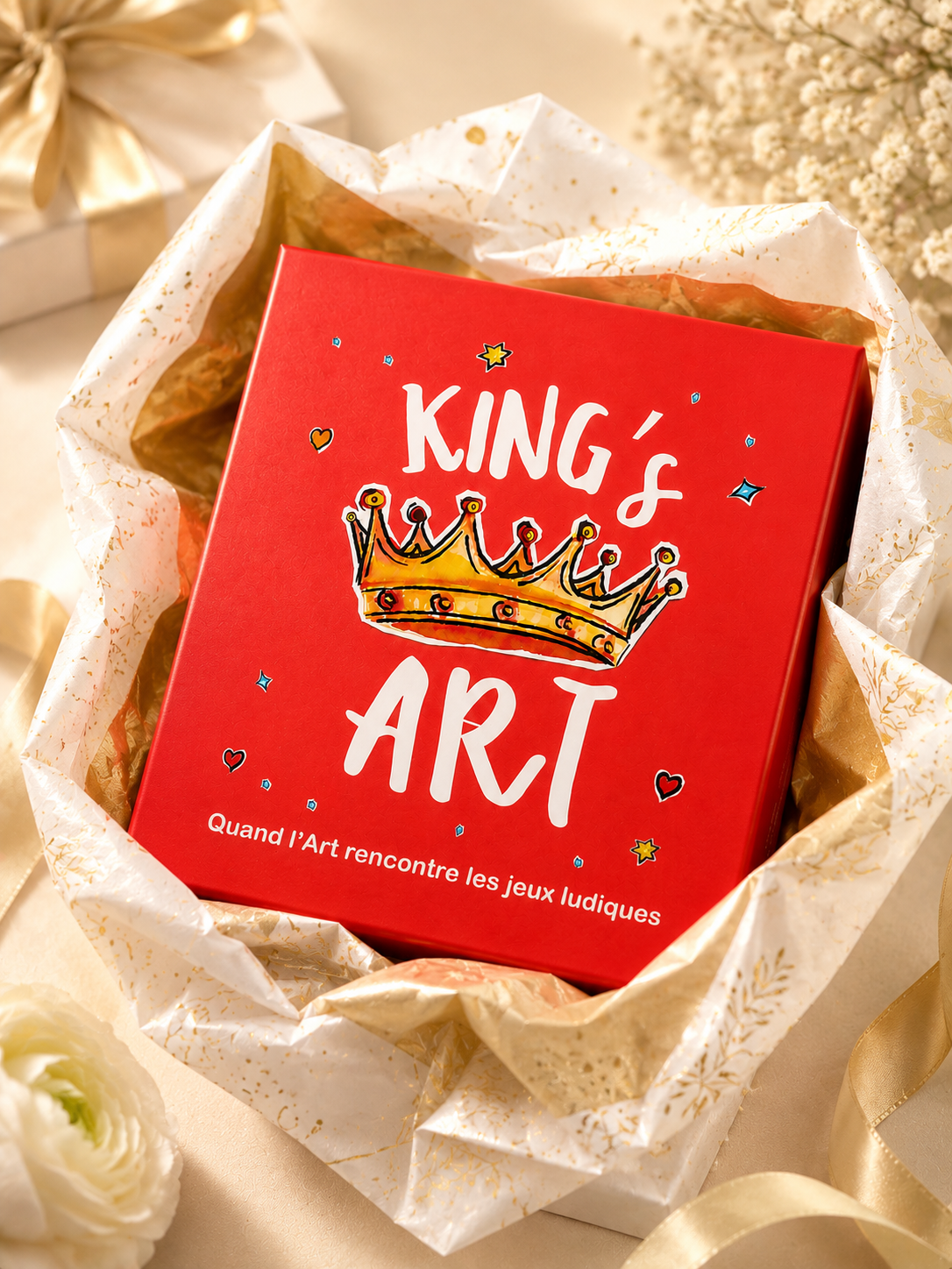 Boite du jeu KING'S ART dans du papier cadeau doré